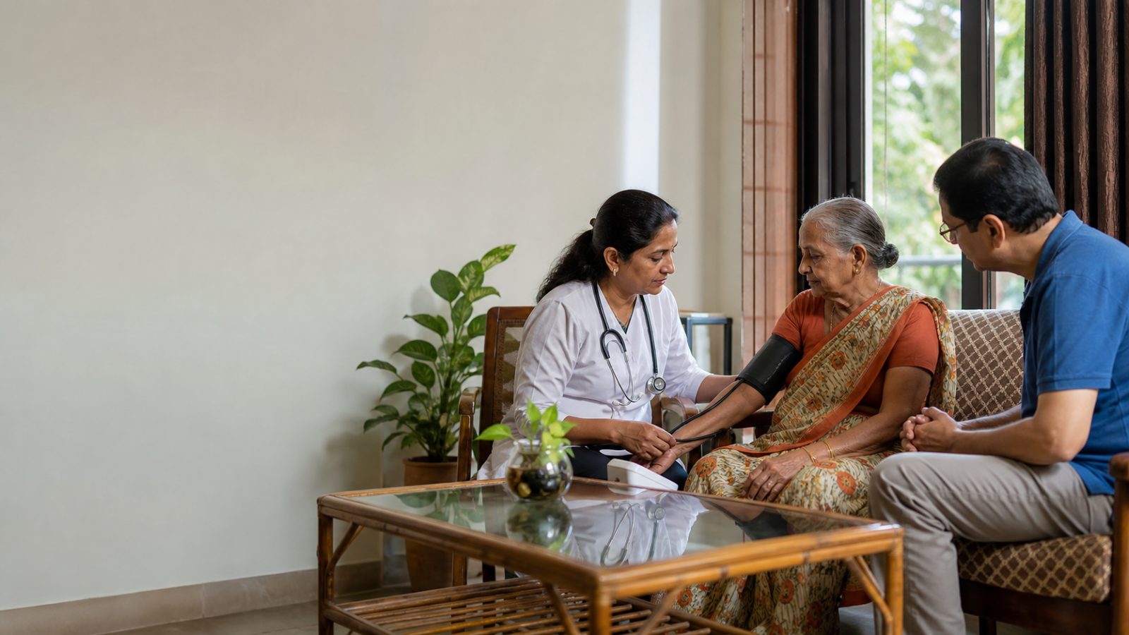 A doctor checking an elderly patient’s blood pressure at home